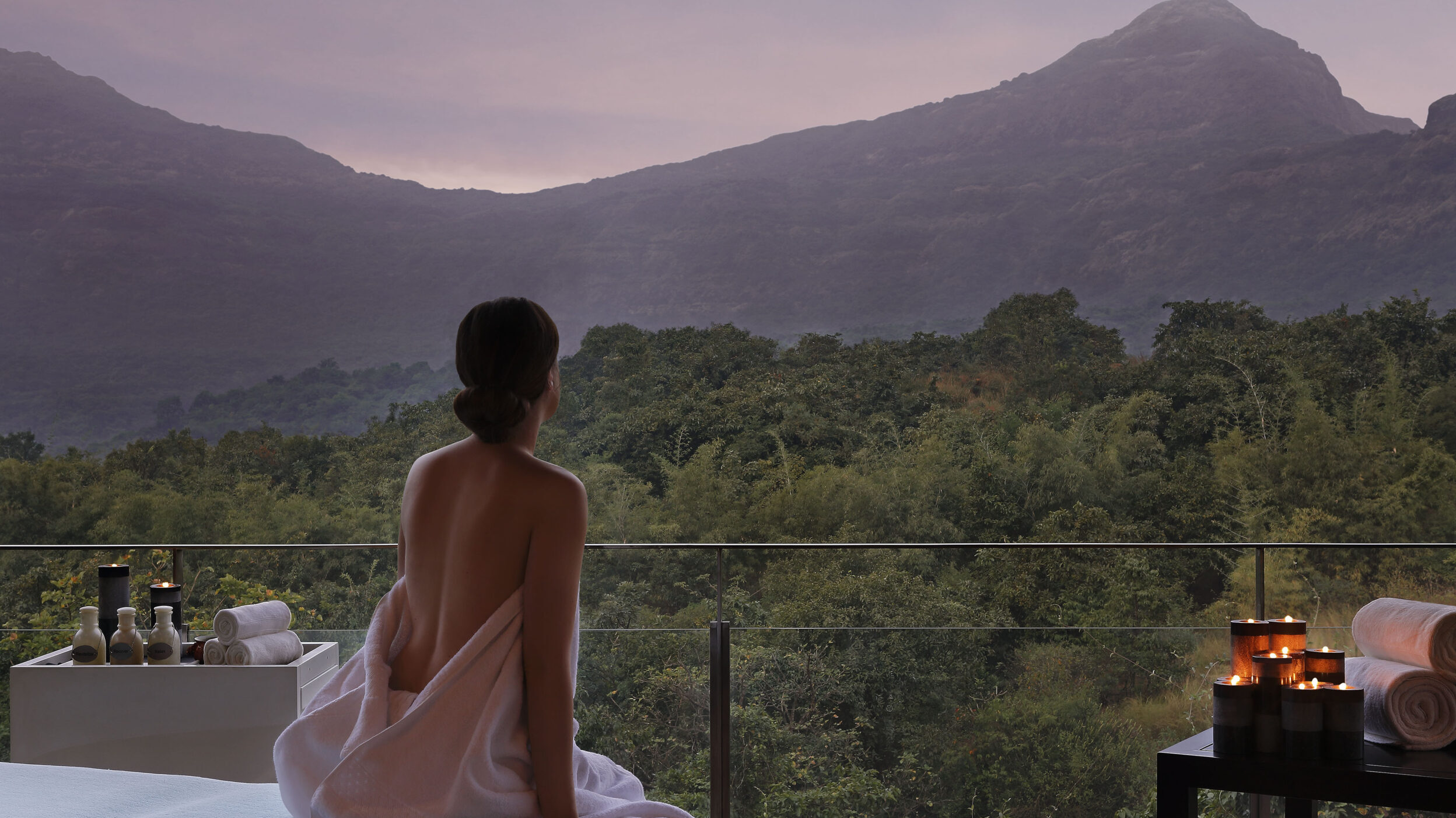 A woman looks at mountains at Hilton Shillim Estate Retreat & Spa. It is a premiere wellness destination