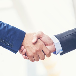 zoomed in image of two businessmen shaking hands