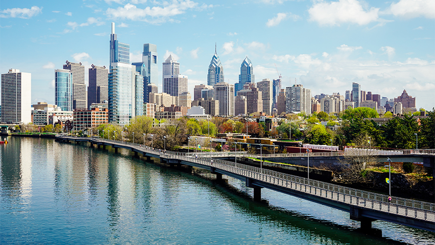 An aerial shot of the Philadelphia skyline next to a river.
