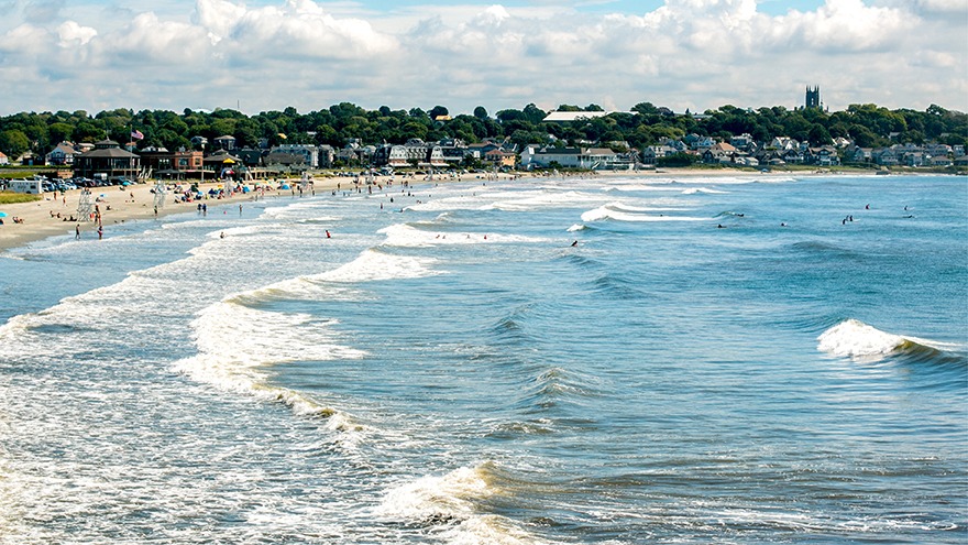 Several distant tourists at Easton's Beach.