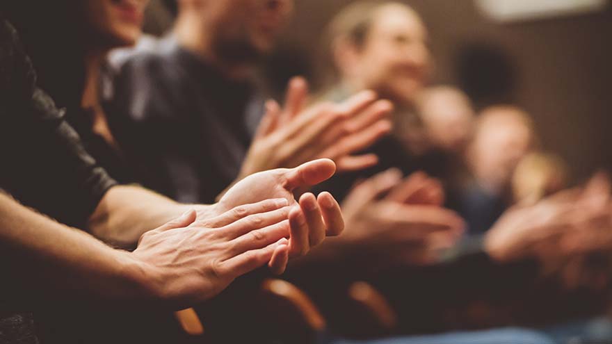 A closeup of people clapping