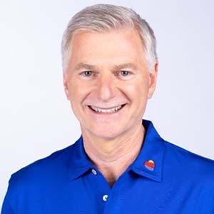 A portrait of Bob Jordan. He is an older white man with combed white hair and a blue polo