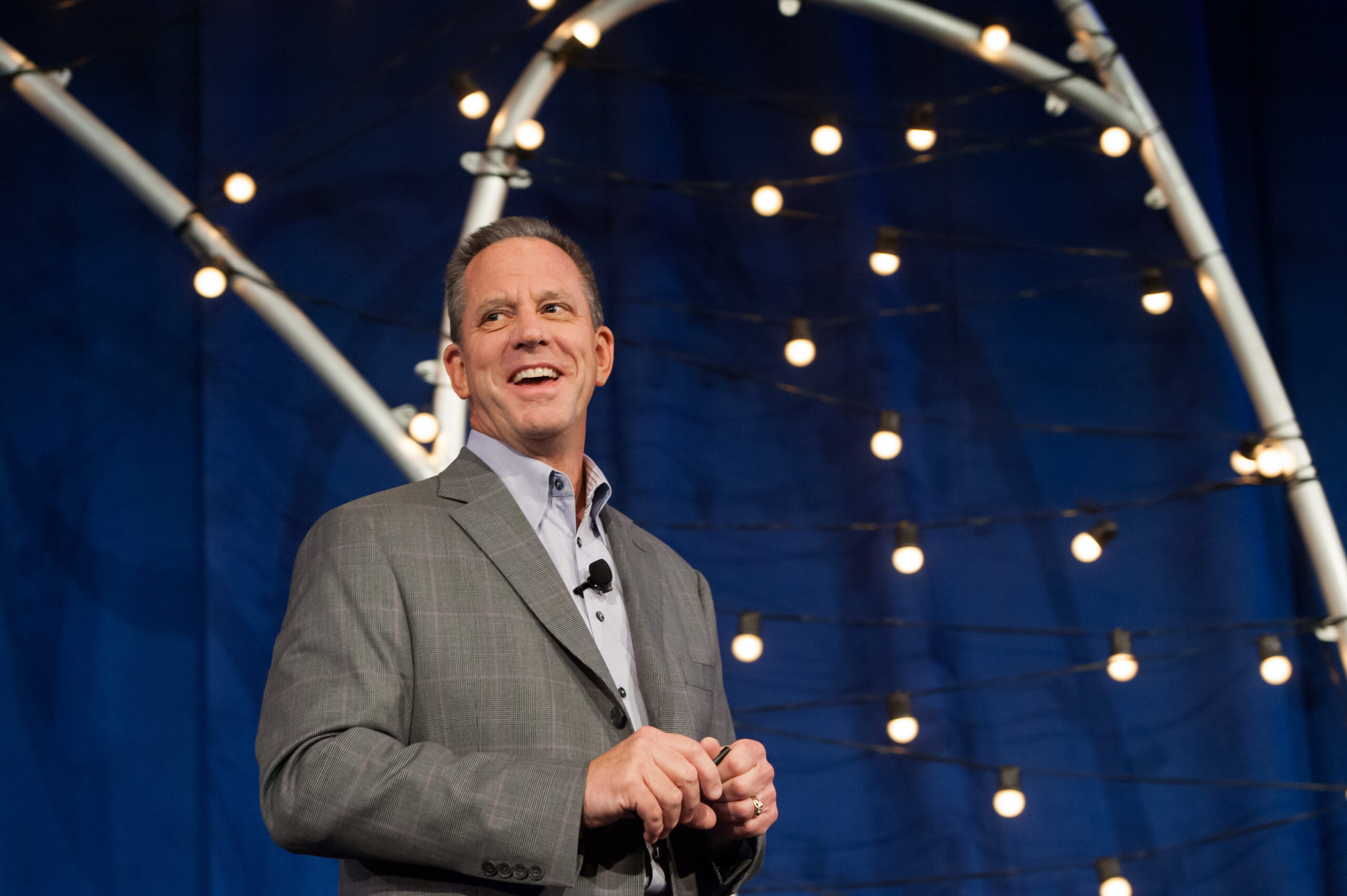 David Peckinpaugh giving a talk in Vegas against a blue backdrop