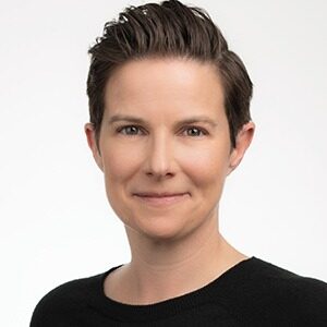 A portrait of Louise Parsons-Davey. She is a white woman with short combed dark hair.