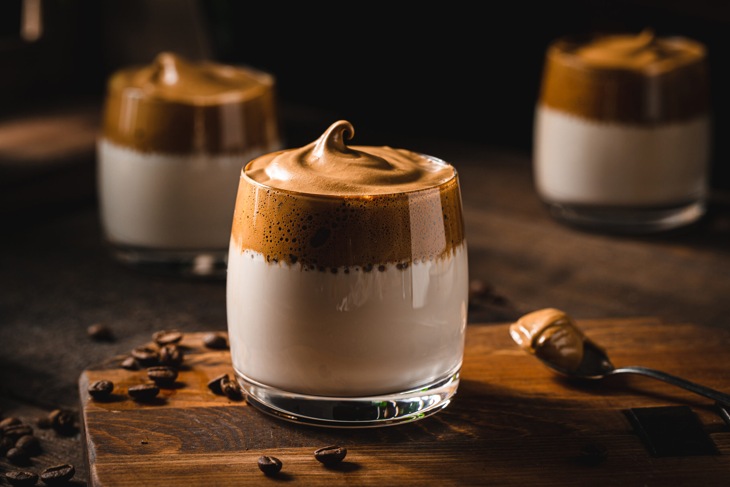 Three short cups holding caffe latte