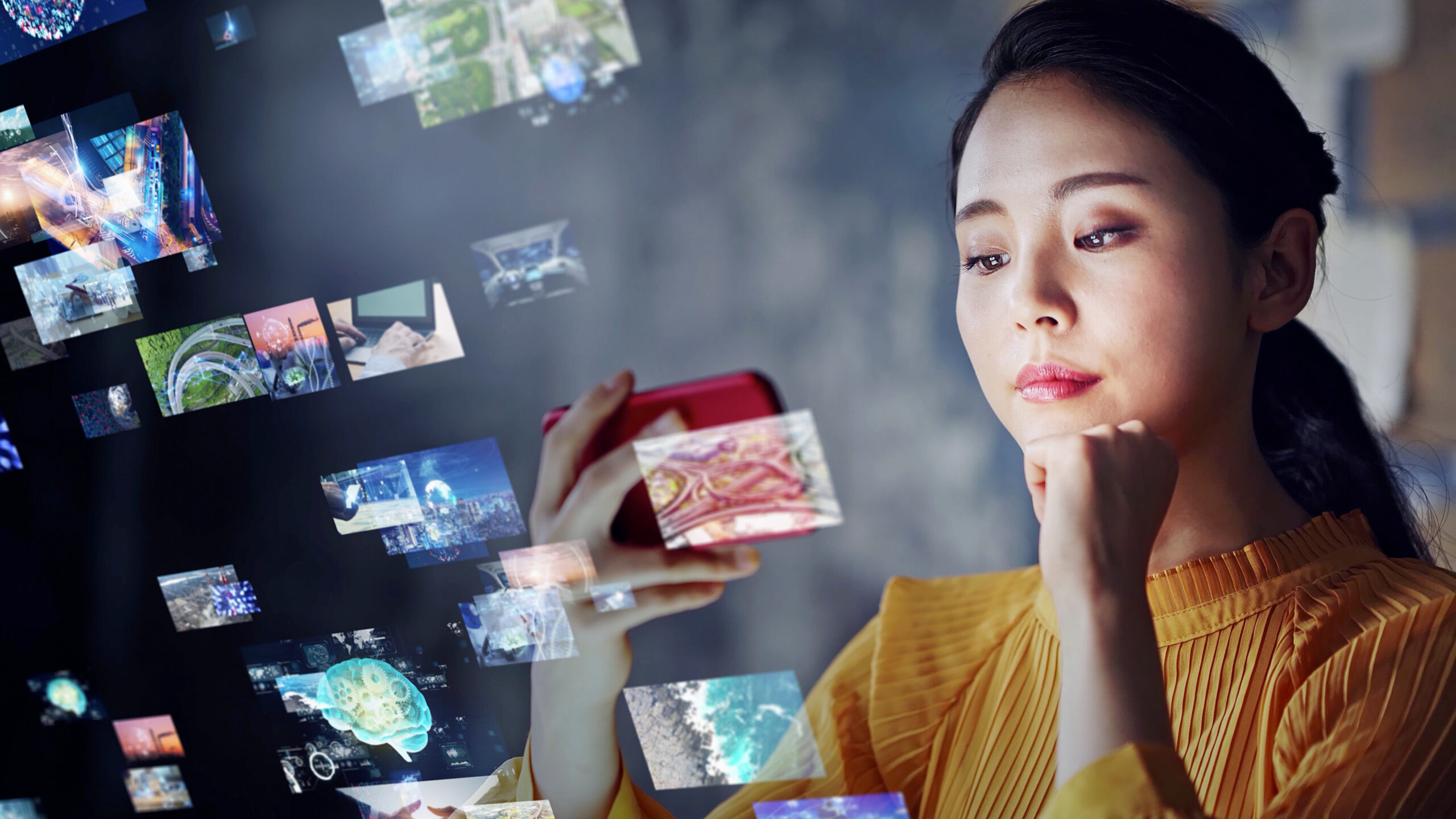 An Asian woman looking at her phone, representing evolving technology