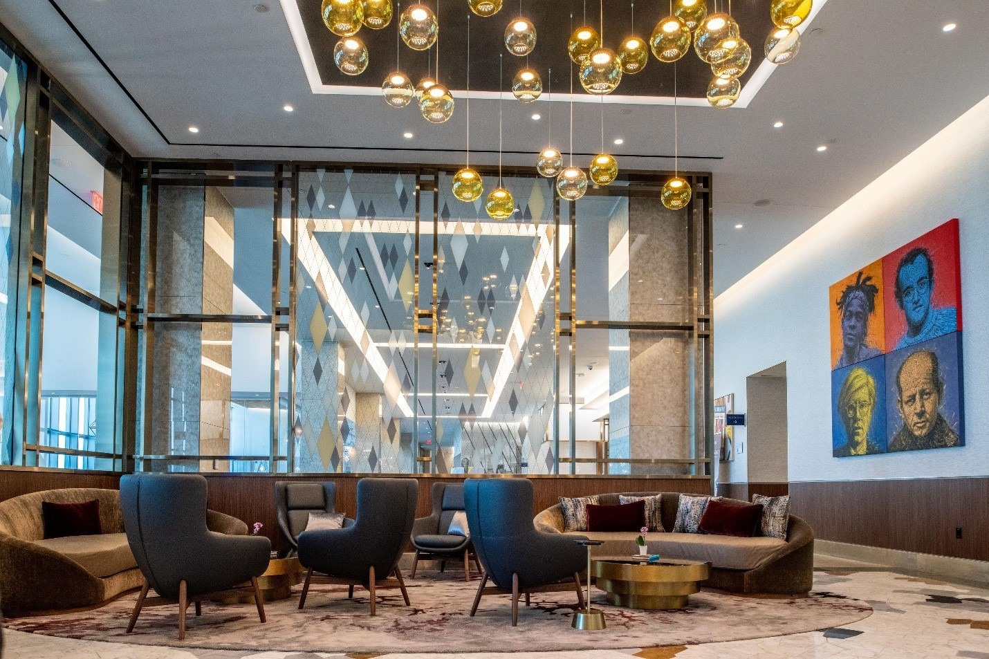 A lounge with hanging lamps and armchairs.