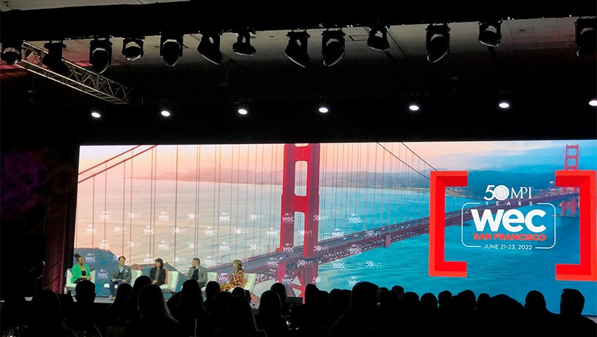 A picture from MPI WEC 2022. It shows a crowd in front of a projection.