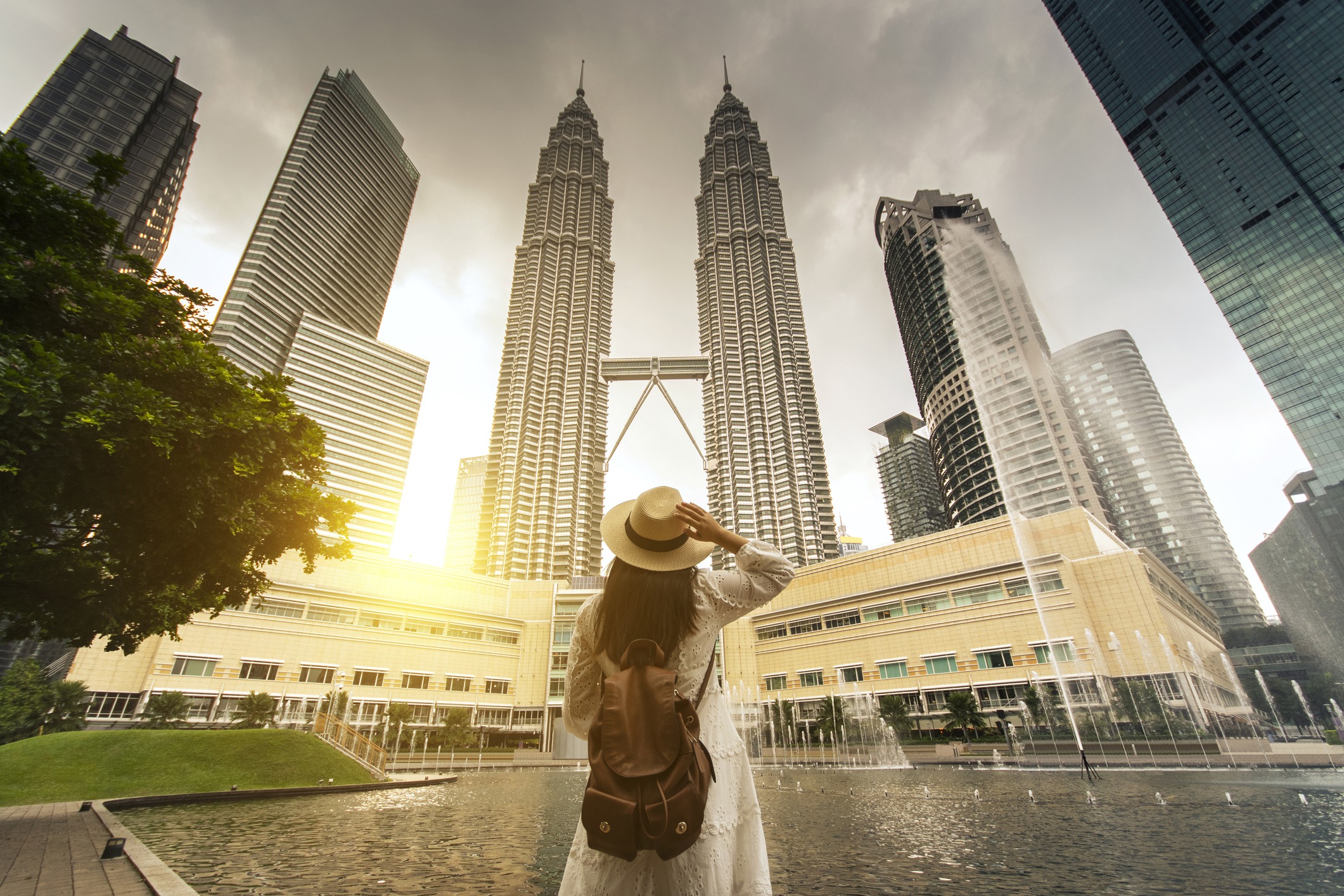 Woman tourist looking at Kuala Lumpur twin tower in Malaysia