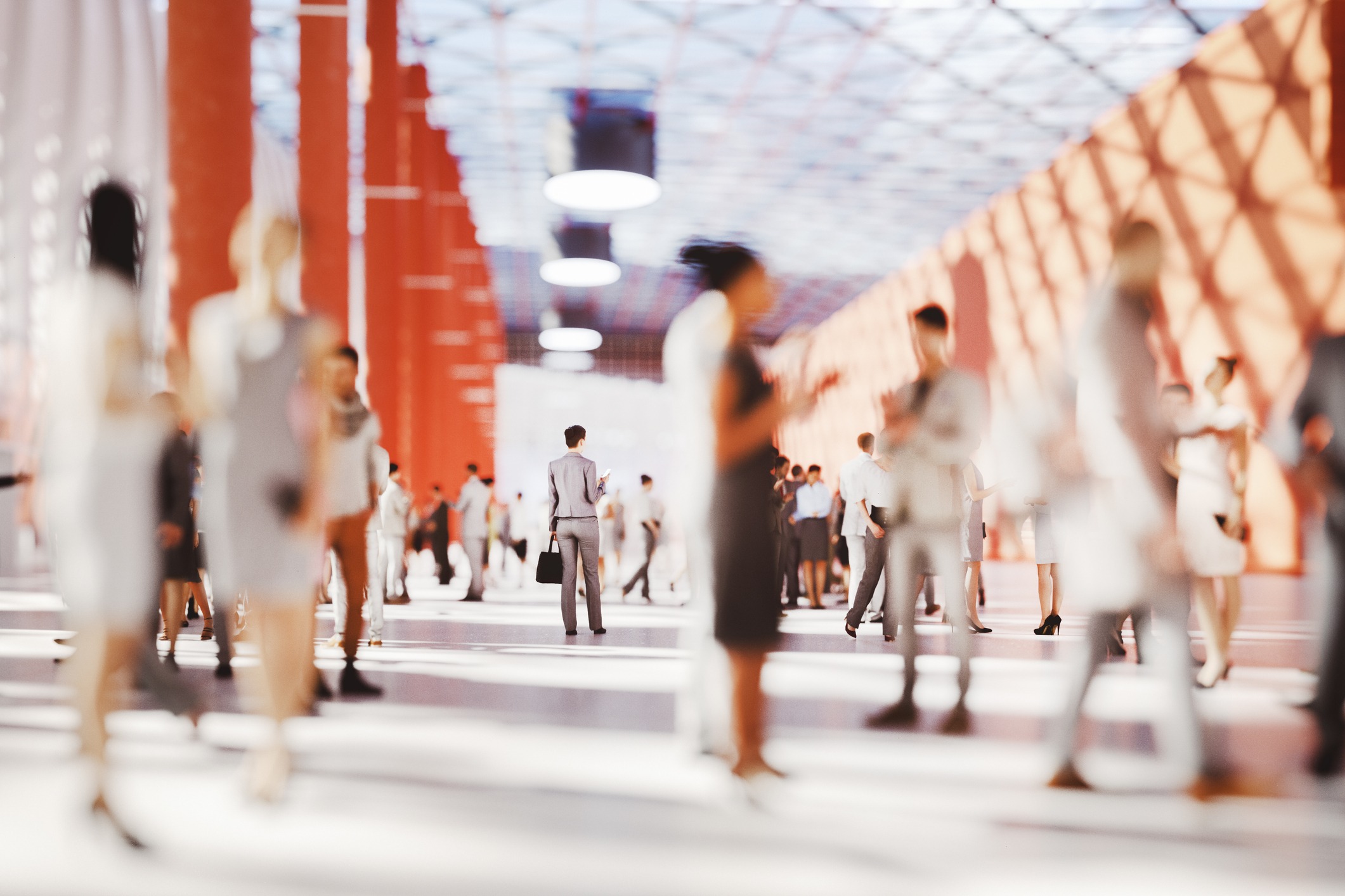 businesswoman standing in crowd of people in conference center