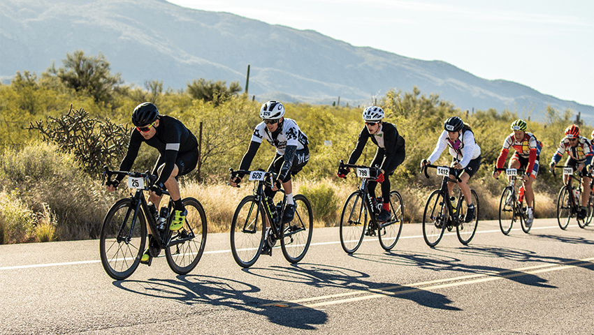 six cyclists riding riding on a road