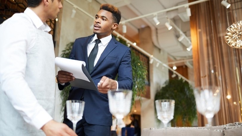 young businessman talking to an employee