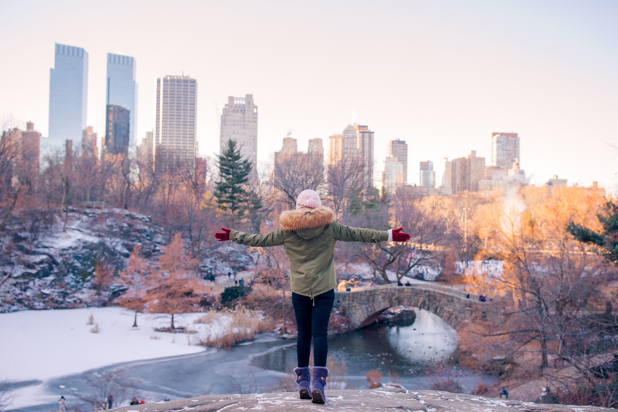 woman stands on rock in park in manhattan