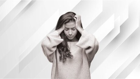 black and white image of worried woman grabbing her head