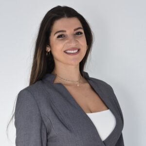 hailey claudio, wearing a light grey blazer and white shirt