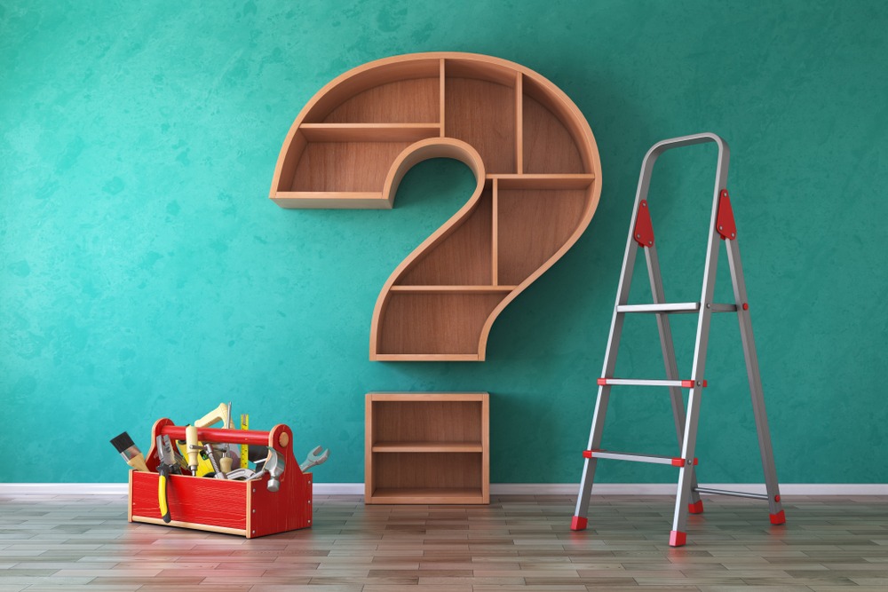 Toolbox full of tools, ladder and bookshelf in form of question mark