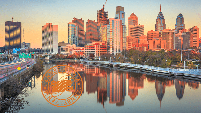downtown philadelphia skyline at dusk on the Schuylkill River with stamp of philadelphia in bottom left-hand corner
