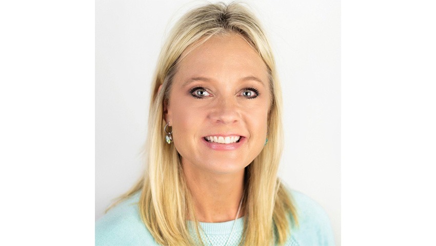 dana chorpenning wearing a teal top and silver necklace