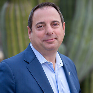 leo percopo wearing light blue dress shirt and dark blue blazer