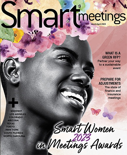 woman with flowers above her head smiling
