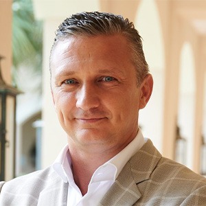 sascha hemmann wearing white dress shirt and light brown sport coat