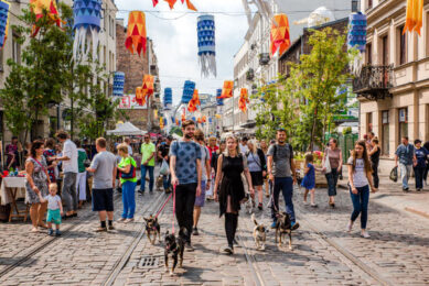 people walking through square in warsaw, poland