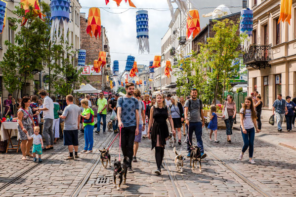 people walking through square in warsaw, poland
