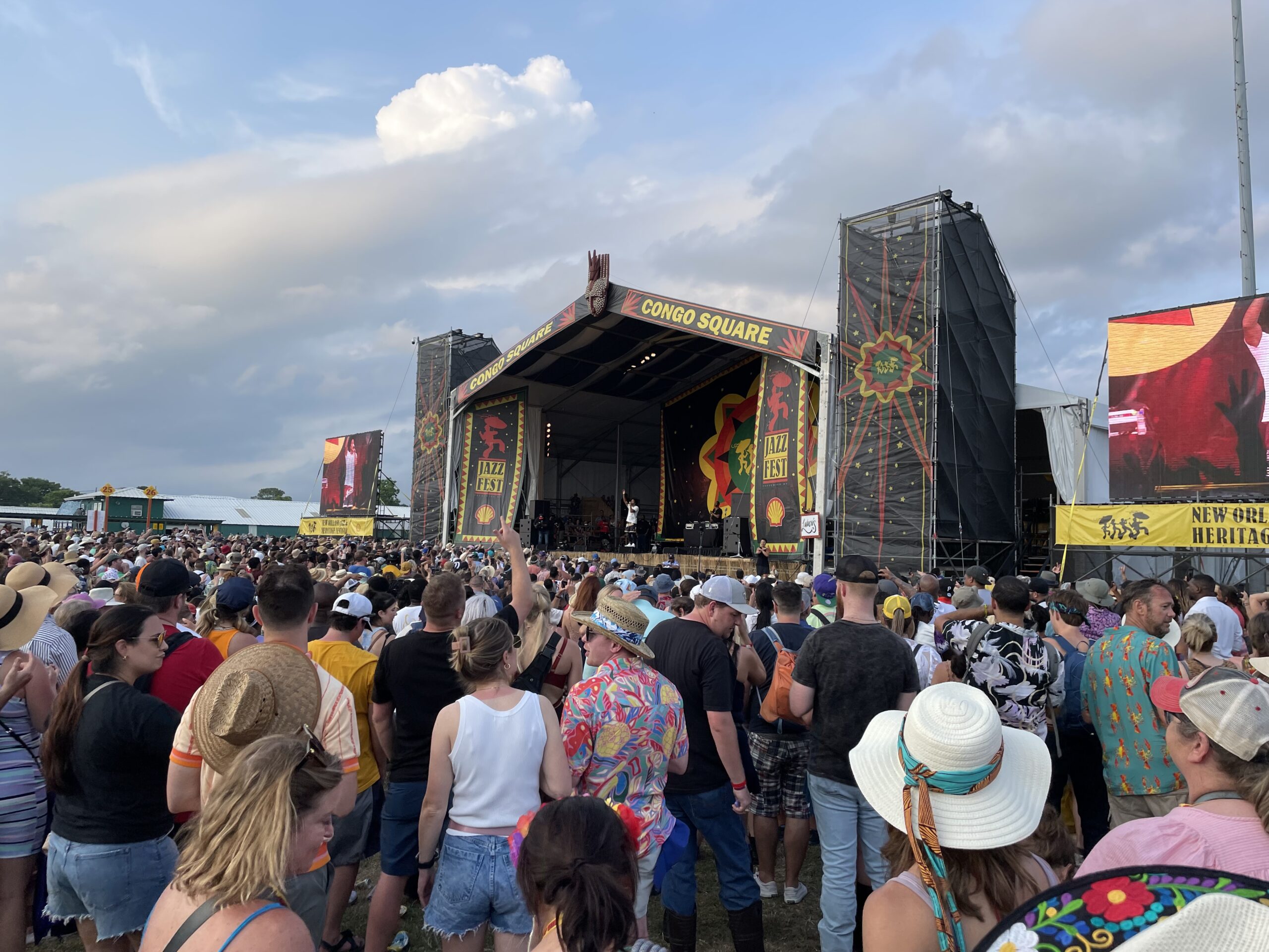 person singing on stage in front of large group of people