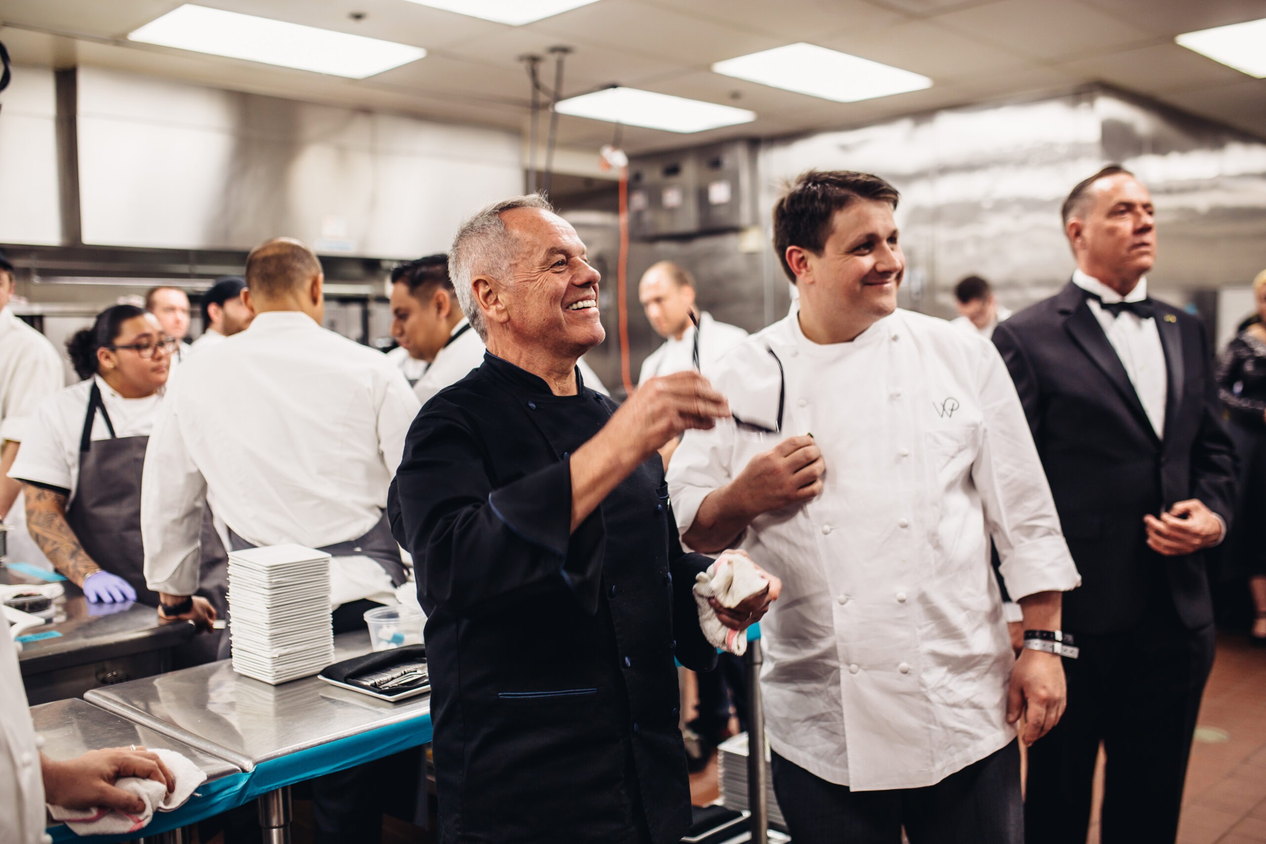 Chef Wolfgang Puck with kitchen staff.