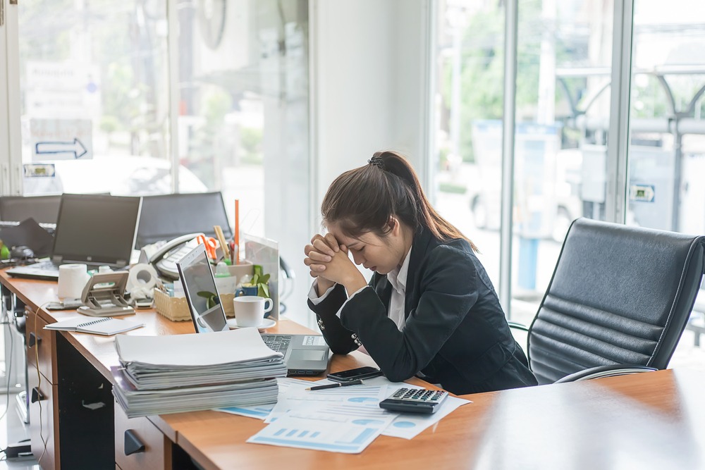 Business woman looks stressed from work in the office