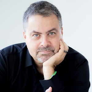 man sitting head in plam, wearing black long sleeve dress shirt