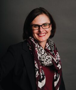 woman with glasses smiling