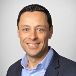 man smiling wearing blue suit