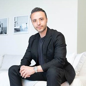 man sitting down wearing black suit
