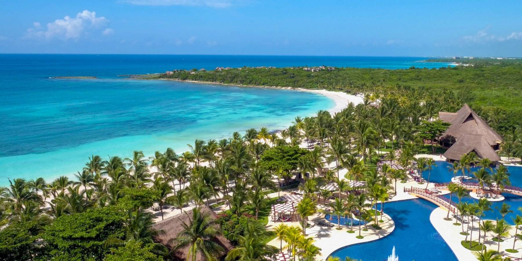 aerial view of resort pool next to beach
