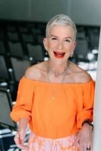 woman wearing orange below-shoulder shirt