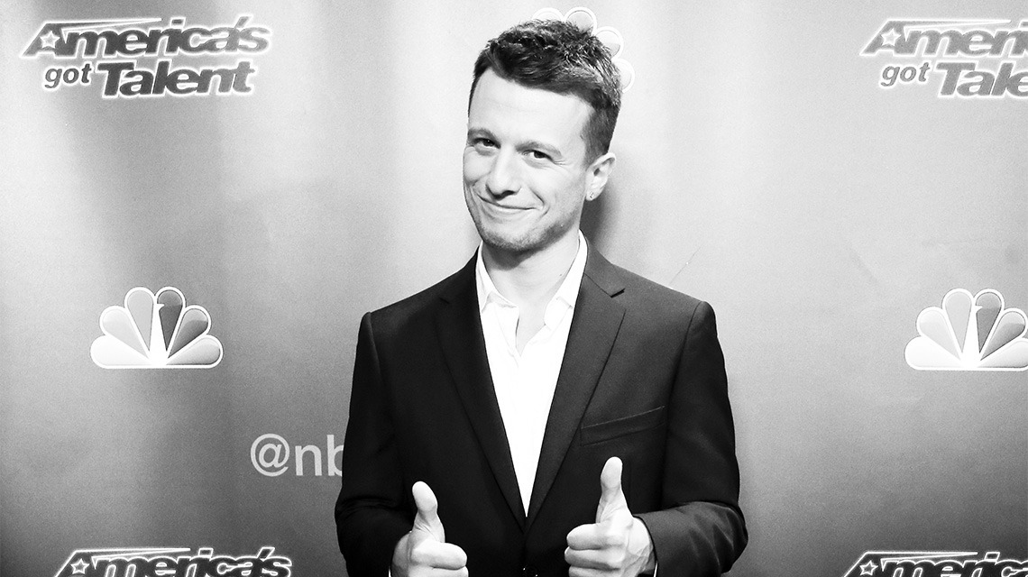 black and white image of man giving thumbs up