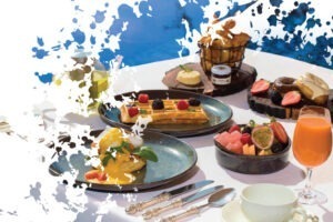 various breakfast foods: waffles, fruits and eggs