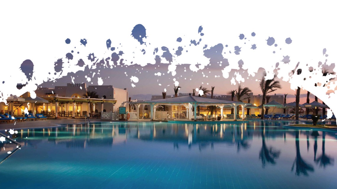 wide shot of hotel with pool in foreground