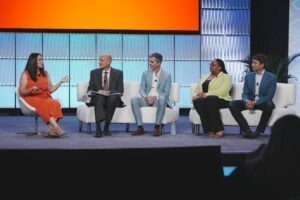 five people on stage talking