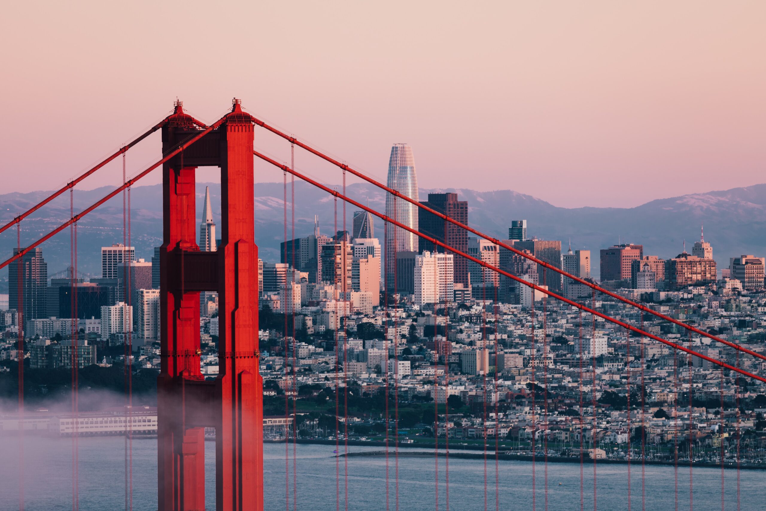 red bridge with city skyline in backgroun