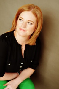 red-haired woman sitting down