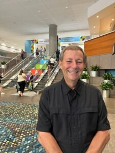 man smiling and posing for picture