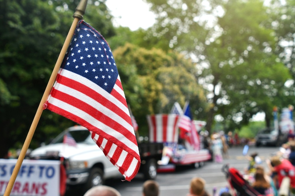american flag in foreground at parade