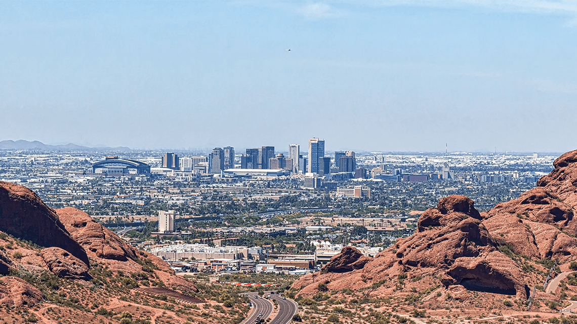 aerial view of city skyline in background and mountains in foreground