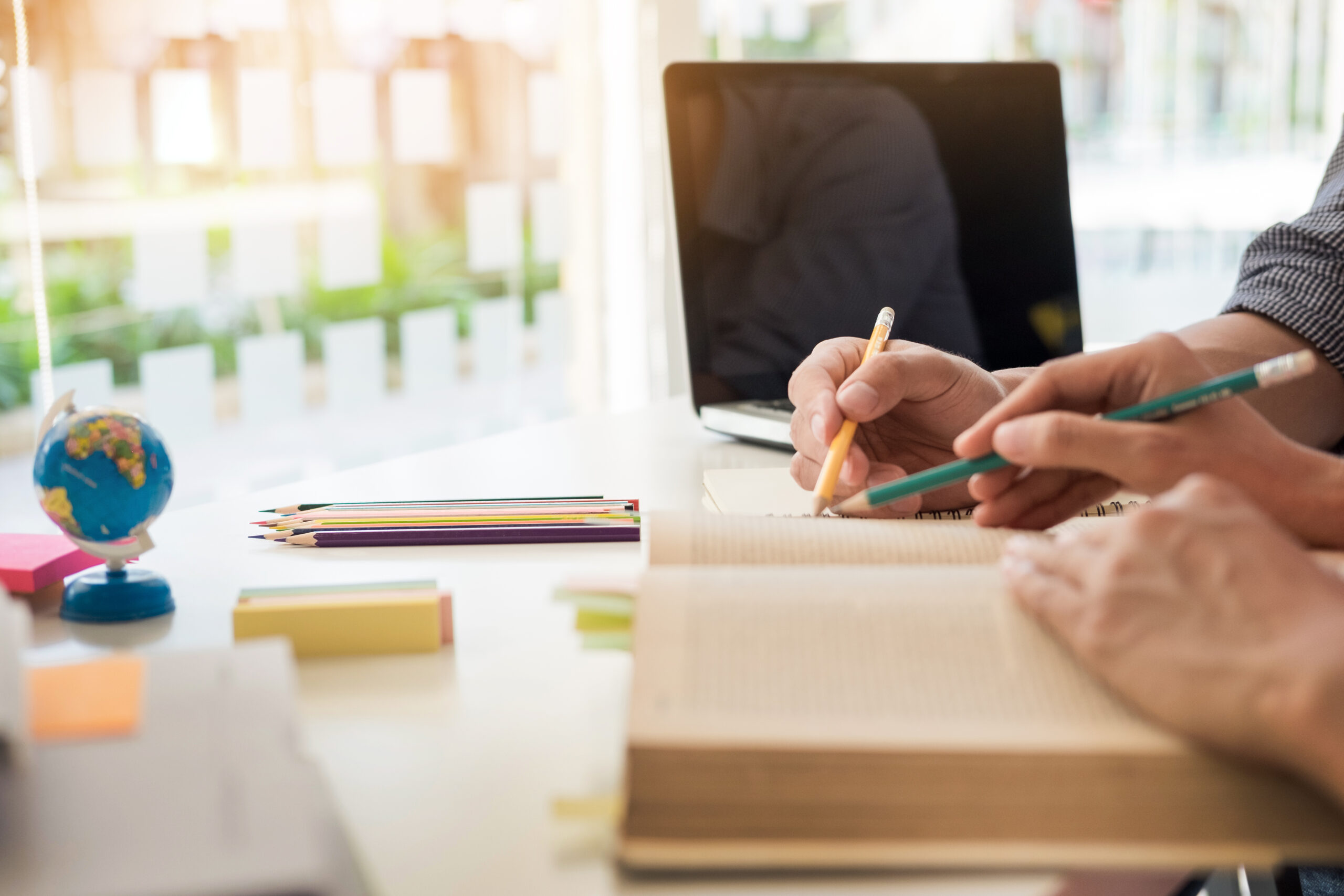 Two CMP students study for the CMP exam together over an open book