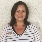 woman wearing striped black and white long sleeve shirt smiling