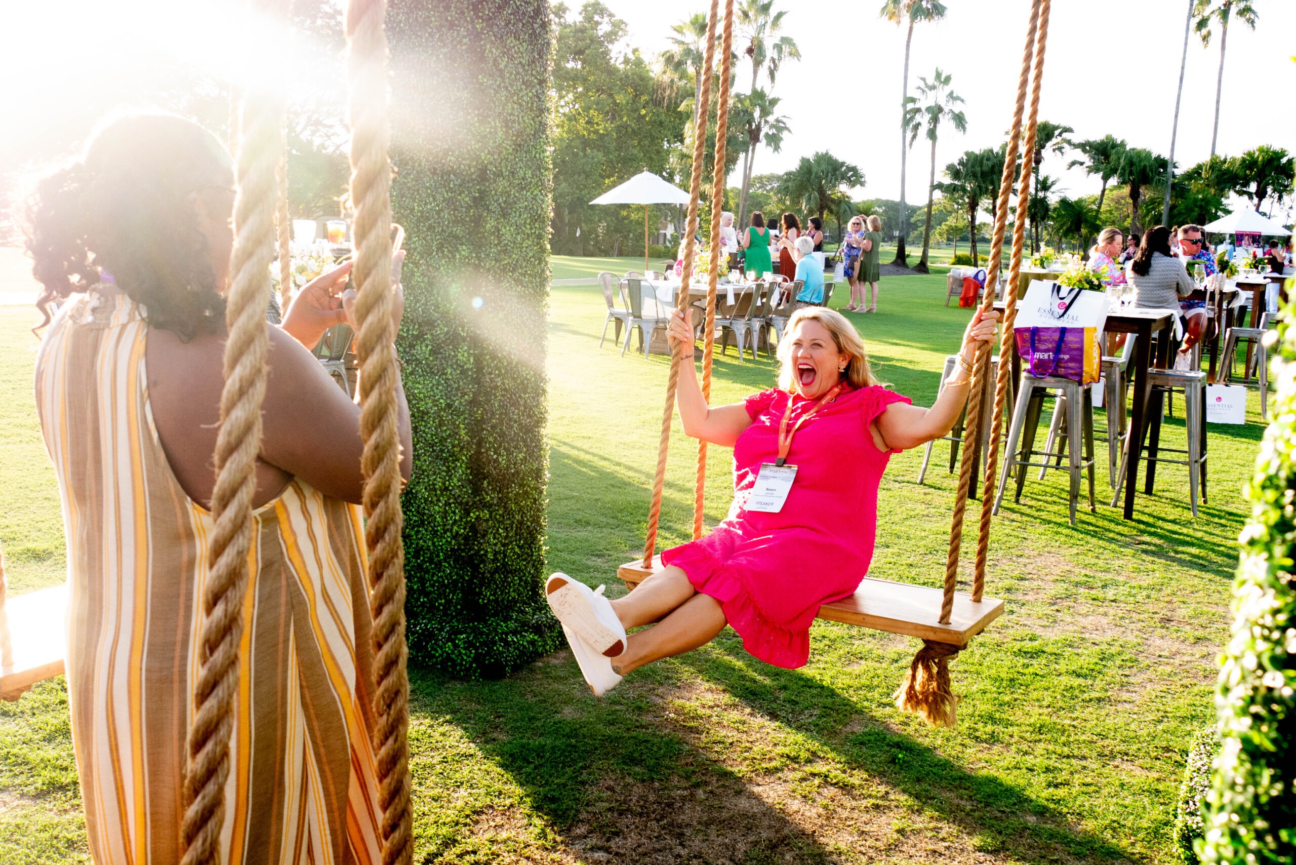 Neen James in a pink dress swinging
