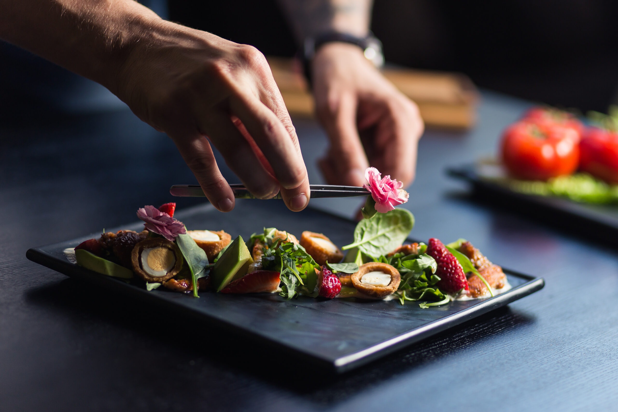 Woman Chefs of Color Featured Image, Chef finishing her plate with final touches
