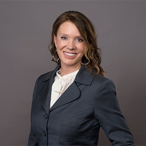woman wearing dark grey coat and white shirt